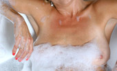 Anilos Vanessa 22988 Experienced cougar Vanessa enjoys her bubble bath with a black vibrator banging her wet hairy pussy