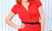 Anilos Sasha Brand 23174 Naughty milf Sasha Brand strips off her clothes and fondles her red haired Anilos pussy on the sofa