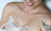 Anilos Justine 23782 Alluring mature lady masturbates in a bathtub filled with bubbles