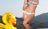 Twistys Emily Addison 25938 Emily Addison lounges around in pool with her rubber ducky

