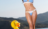 Twistys Emily Addison 25938 Emily Addison lounges around in pool with her rubber ducky
