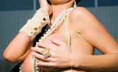Penthouse Nikki Benz Nikki Benz exudes that Old Hollywood screen diva sex appeal as she struts around and fools around with herself in a flowing scarf/headwrap, silver sequined swimsuit and ropes of pearls and gold bling!
