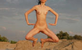 Met Art Alisa B Danceuse by Skokov 39282 Brunette displays her flexibility and long legs in the sand by the beach.
