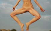Met Art Alisa B Danceuse by Skokov 39282 Brunette displays her flexibility and long legs in the sand by the beach.
