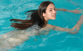 Met Art Sofia C Blu by Slastyonoff 39938 Long dark hair flows through water like a breeze as this pretty naked model swims.
