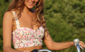 Met Art Mango A Calesma by Vlad Kleverov 45286 Fun, carefree and refreshingly cute, Mango exudes a pretty girl-next-door in her floral corset, skimpy pink skirt, and embellished sandals as she frolic on the grassy prairie with her bicycle.
