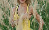 Met Art Taylor A Potenco by Alex Iskan 45788 With a confident, charming allure, Taylor is a stunning sight as she strips her hot yellow dress amidst the tall, verdant grass and tree.
