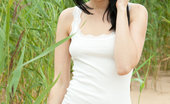 Met Art Lily J Naturo by Koenart 46157 With a confident, youthful allure, Lily is a stunning sight as she strips her sexy white dress amidst the tall, verdant grass and sandy shore.
