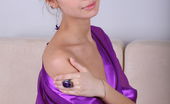 Met Art Irina J Acima by Flora 46866 Garbed in a sliky lavendar robe and purple panty, Irina J spreads her legs wide open on top of the couch.
