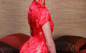 Met Art Irina B Otono by Oleg Morenko 46867 Irina B exudes a sultry doll dressed in a bright red cheongsam.
