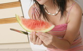  Teen poses with a watermelon
