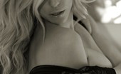 XO Gisele 85700 Shoots A Sexy Boudoir Set With A Tight Corset And Black Fishnets And Ends Up Nude Under The Sheets
