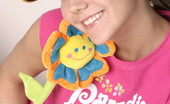 Andi Pink 104354 Cute teen plays with flower
