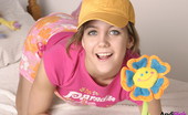 Andi Pink 104354 Cute teen plays with flower

