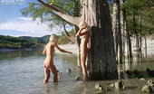 Amour Angels Natasha And Anna ANNA & NATASHA 105763 Amazing view of the trees and warm water make these cute lesbian girls remove clothes and start posing.