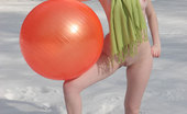 Amour Angels Nusia NUSIA BALL 105866 Naked girl in scarf posing with big red ball on white snow not feeling cold