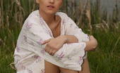 Amour Angels Olga WILD COAST 106079 Perfect nude teen with extremely killing piercing in her belly has a rest near a desert forest near the river.