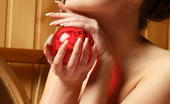 Amour Angels Sveta MAGIC SPHERE 106138 Long-haired teen girl with beautiful eyes is as sweet as this big, red apple in her hands.
