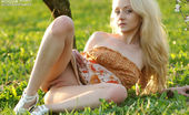 Amour Angels Mirabell BLOSSOM GIRL 106428 This time blonde girl poses in dress on the grass and shows carefully shaved pussy in heat.