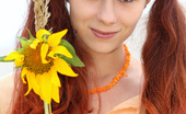 Amour Angels Anika AQUARELLE 106470 Cheerful teen girl poses with a sunflower then strips down totally naked.