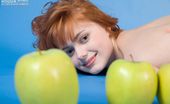 Amour Angels Malena PRETTY 106554 Jolly teen redhead poses naked with apples demonstrating the most intimate parts of her body.