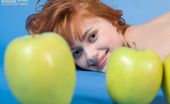 Amour Angels Malena PRETTY 106554 Jolly teen redhead poses naked with apples demonstrating the most intimate parts of her body.