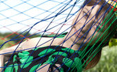 Amour Angels Sophy PURE DELIGHT 106569 Cute teen girl lounges in a hammock and shows us she wears nothing underneath her dress.