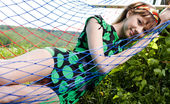 Amour Angels Sophy PURE DELIGHT 106569 Cute teen girl lounges in a hammock and shows us she wears nothing underneath her dress.