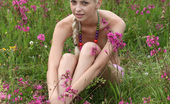 Amour Angels Linda BRIGHT SUMMER 106700 Nice blond teenie with a petite body playfully poses in the nude among the wild flowers.