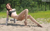 Amour Angels Lilya SLENDER 106715 Sweet teen chick shamelessly gets on all fours on the sand to show her tight ass and pussy.