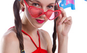 Amour Angels Sunny TEEN PARTY 106798 Gorgeous dark haired teen girl with red glasses in the shape of hearts posing with tape recorder.