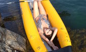 Amour Angels Alexa KAYAK 106810 Wonderful long haired girl taking off swimsuit and showing shaved pussy in a yellow boat.