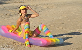 Amour Angels Tandy COLORFUL BEACH 106960 Gorgeous teen beauty in bright stockings showing hot body on the air mattress on the beach.