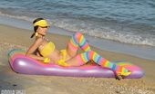 Amour Angels Tandy COLORFUL BEACH 106960 Gorgeous teen beauty in bright stockings showing hot body on the air mattress on the beach.