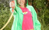 Club Seventeen 116932 Brunette teenage girl playing with a water hose outdoor
