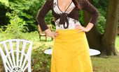 Only Opaques Carla 174308 Brunette Outside Wearing A Long Yellow Skirt And Brown Top With Brown Pantyhose.
