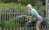 Errotica Archives Juntarse Leonie With A Cute And Charming Smile On Her Pretty Face, Leonie Strips Off Her Shirt And Denim Shorts In The Garden Before Enjoying The Refreshing Cool Water From Th Garden Hose. Flora
