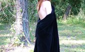 Amber Lily 228466 Stripper In Black Velvet Casts Sexy Magic Spell Outside In The Woods.
