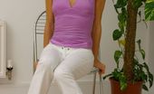 Only Melanie 234232 Melanie Relaxes In A Chair Wearing Delightful Tight White Trousers

