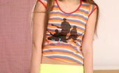 Nubiles Olivie 249991 Cute Teen Olivie Posing In Her Orange Bra And Takes Off Her Green Mini-Skirt
