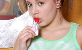 Nubiles Lollie Sweet Teen Lollie Sucks On A Red Lollipop With Her Hair Tied Up
