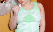 Nubiles Lollie 250344 Sweet Teen Lollie Sucks On A Red Lollipop With Her Hair Tied Up
