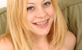 Nubiles Leah 251821 Sitting Topless On Her Couch Leah Smiles With Her Mouth Full Of Braces And Touches Herself
