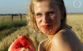 Girls Out West Gretel Watermellon 303921 Sweet And Succulent Gretel Takes A Break From Her Busy Backpacking Schedule And Jumps In The Wheat Field With A Giant Big Red Watermelon.