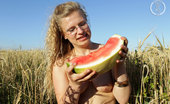 Girls Out West Gretel Watermellon 303921 Sweet And Succulent Gretel Takes A Break From Her Busy Backpacking Schedule And Jumps In The Wheat Field With A Giant Big Red Watermelon.