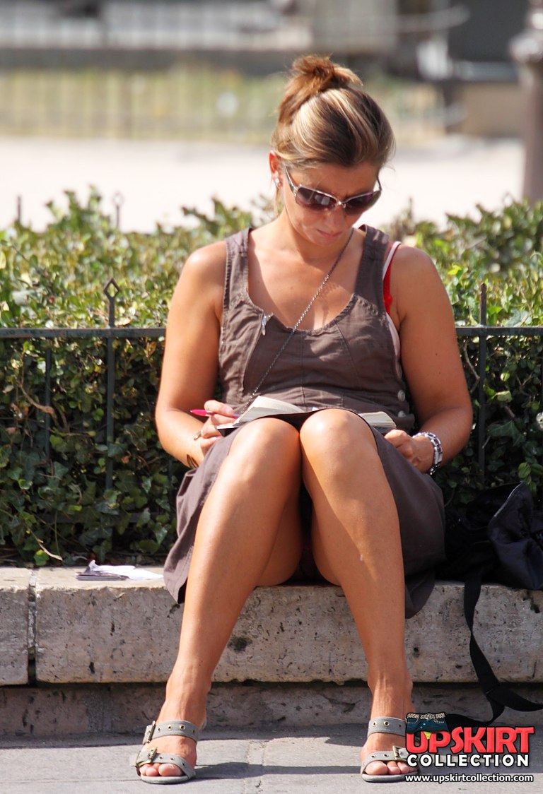 Girl sitting on hunkers and showing shorts upskirt