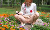 Hot Pissing 419744 Flowerbed Piddling Naughty Wench Squats In The Middle Of A Flowerbed And Makes A Pee-Pee
