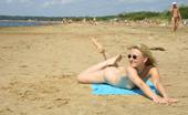 X Nudism 453512 All Eyes Are On This Young Nudist As She Sunbathes
