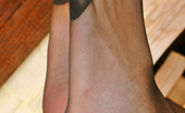 Nylon Feet Line 481850 Melanie Amazing Babe In Black Reinforced Toe Pantyhose Playing With Orange On Floor Nylon Feet Line
