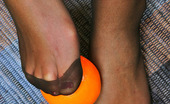 Nylon Feet Line 481850 Melanie Amazing Babe In Black Reinforced Toe Pantyhose Playing With Orange On Floor Nylon Feet Line
